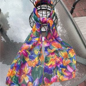 Pretty and bright floral print scarf. Tie it or belt it.  55" long x 13" wide.